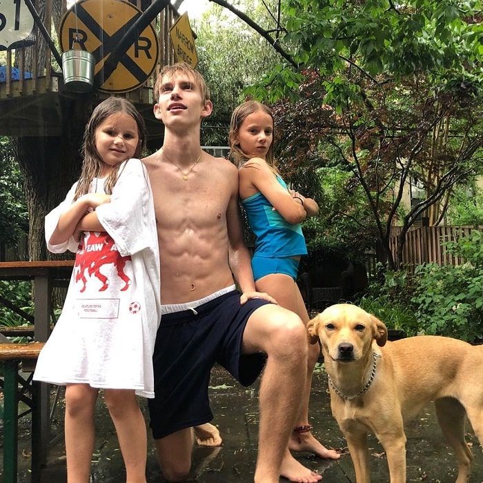 Levon with two of his sisters and their doggo.